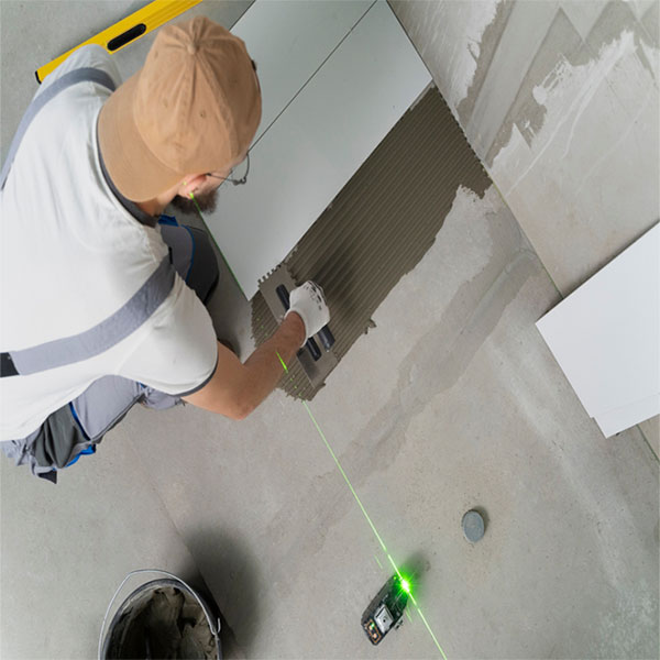 A male contractor resurfacing the concrete to start an epoxy flooring in Palm Beach Gardens, FL.