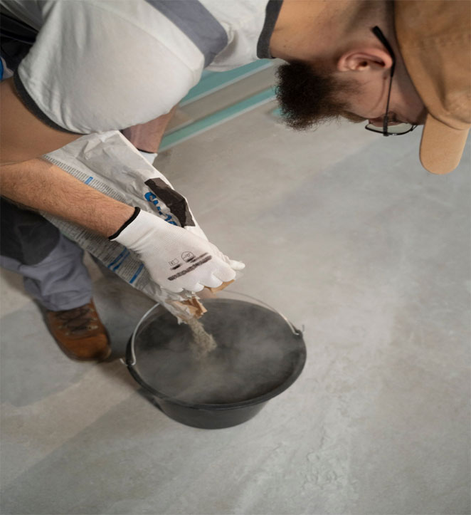 Palm Beach Coatings male contractor mixing an epoxy paint.